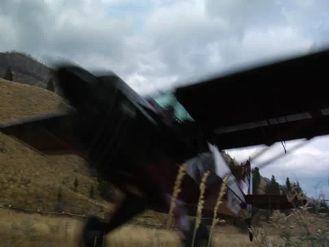 Plane taking off in back country 01 Stock Footage 24654692