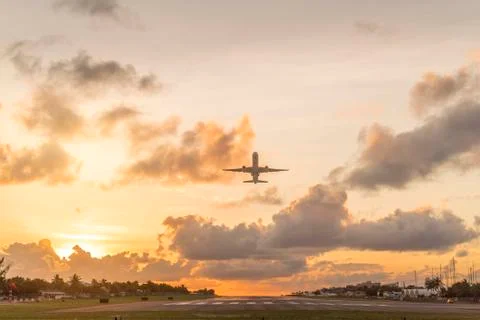 Plane taking off during sunset on st.maarten Stock Photos