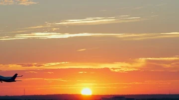 Plane taking off at golden sunset Stock Footage 85523357