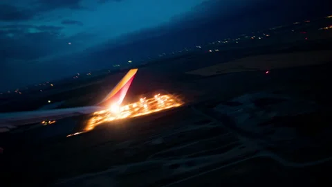 Plane taking off at night Stock Footage 154899693