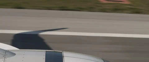 Plane taking off the runway with the shadow of the wing, view from the plane Stock Footage 127135647