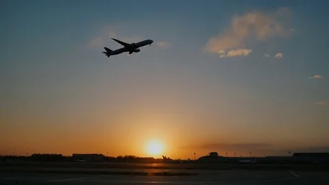 Plane taking off sky sunset sun dusk in airport China. Beijing. Stock Footage 84328001
