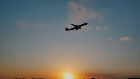Plane taking off sky sunset sun dusk in airport China. Beijing. Stock Footage 84328094
