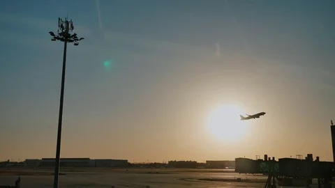 Plane taking off sky sunset sun dusk in airport China. Beijing. Stock Footage 84328433