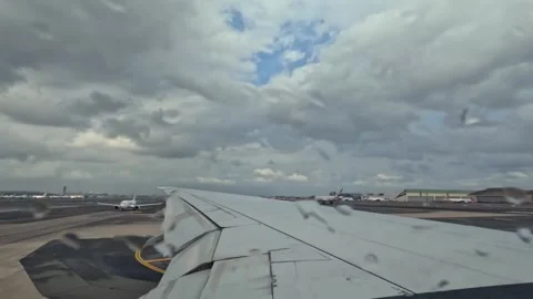 Plane taxiing for takeoff, wing view of emirates flight from Dubai to Seychelles Stock Footage 324842423