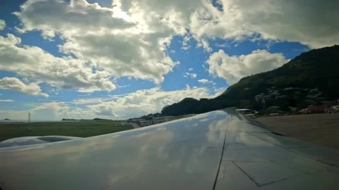 Plane taxiing for takeoff, wing view of emirates flight from Seychelles to Dubai Stock Footage 324883792