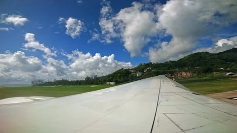 Plane taxiing for takeoff, wing view of emirates flight from Seychelles to Dubai Stock Footage 324883876