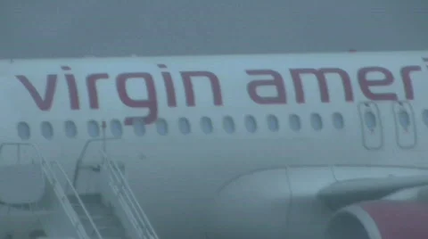 Plane taxing down rainy runway Stock Footage 698997
