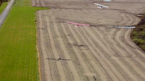 Plane tows a glider over plowed fields.Aerial view. Stock Footage 126661875