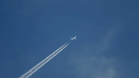 Plane trail in the blue sky Stock Footage 167078393