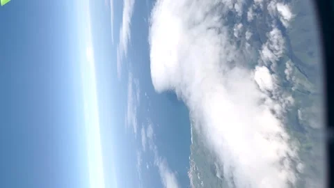 Plane trip above the clouds, with a third island of the Azores visible 動画素材 286087563