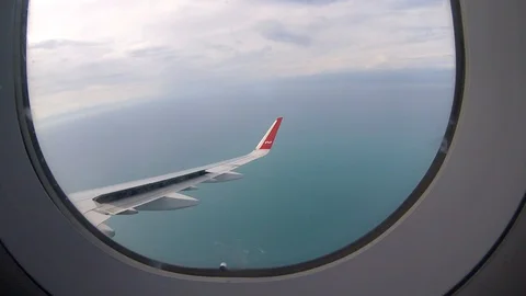 In plane view from the airplane window to the sea Stock Footage 127684373