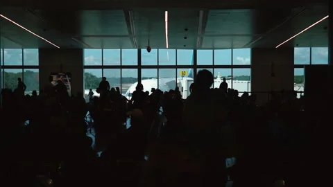Plane view from inside and full of people terminal, gate waiting hall seats Stock Footage 171400469