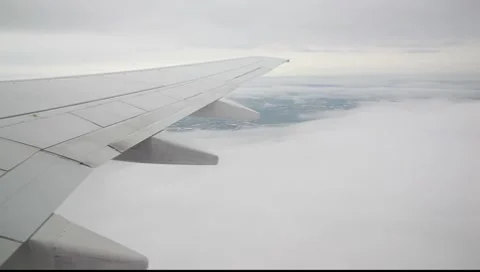 Plane - View over the sky with a opening in the cloudcover Stock-Footage 7908013