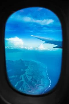 Plane view from window during flight above Tahiti island. Aerial landscape of Stock Photos