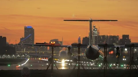 Plane waiting on runway at sunset Stock Footage 95958737