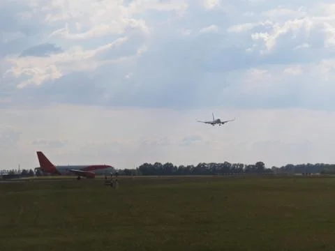 Plane Waiting for Start While Another Plane is Landing at Airport Stock Photos