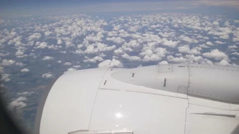Plane window engine with fluffy clouds Stock Footage 156406859