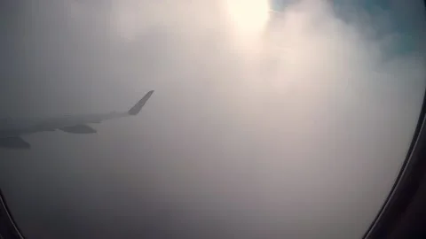 Plane window seat view of the clouds Stock Footage 135393239
