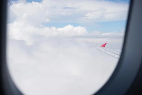 Plane window view with blue sky and sea Stock Photos
