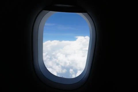 Plane window view with blue sky and sea Stock Photos