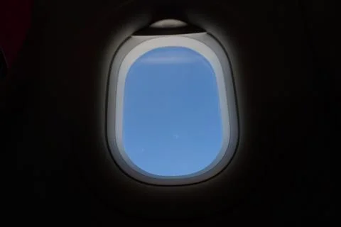 Plane window view with blue sky and sea Stock Photos