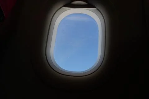 Plane window view with blue sky and sea Stock Photos