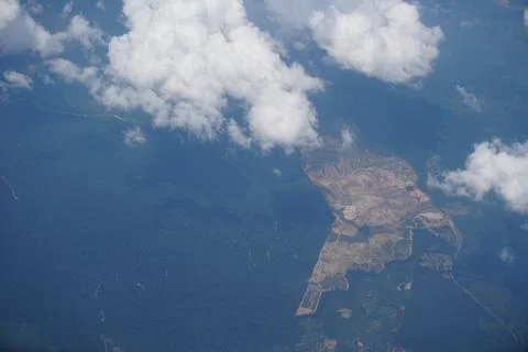 Plane window view with blue sky and sea Stock Photos