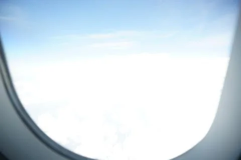 Plane window view with blue sky and sea Stock Photos