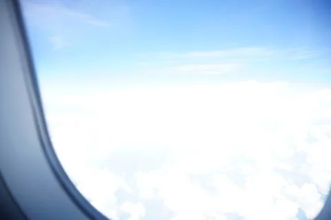 Plane window view with blue sky and sea Stock Photos
