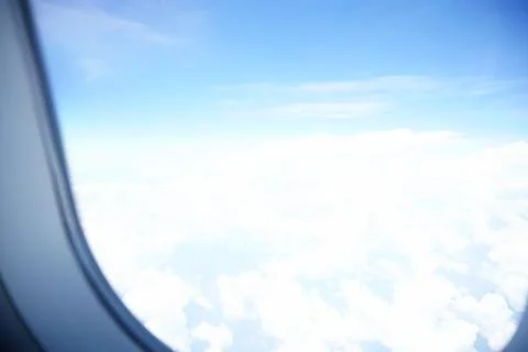 Plane window view with blue sky and sea Stock Photos
