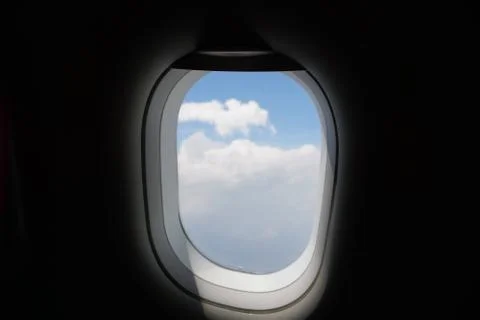 Plane window view with blue sky and sea Stock Photos