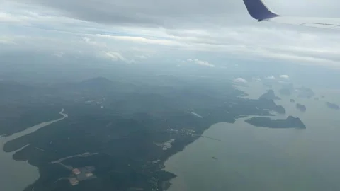 Plane window view fly over Phuket Island in Thailand Southeast Asia travel Stock Footage 340543283