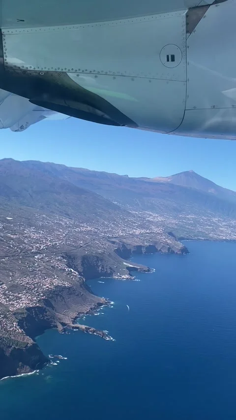 Plane window view to Tenerife and volcano Teide and the coast Stock Footage 310212371