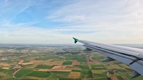 Plane Window View: Wing and Fields Below Stock Footage 309569339
