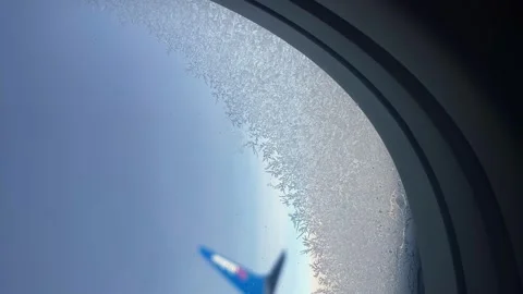 Plane window. the window of the plane. a frozen window on an airplane Stock Footage 276093969