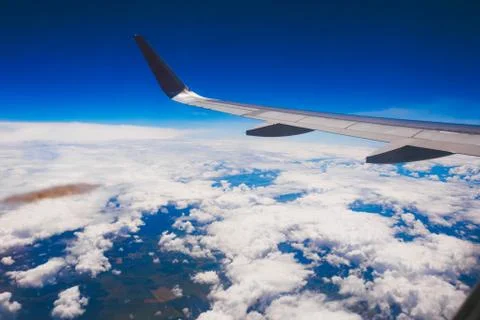 Plane wing above the clouds. Plane flying over the clouds Stock Photos