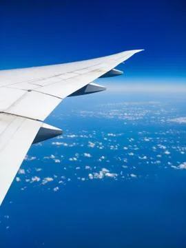 Plane wing above the clouds view clear sky Stock Photos