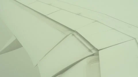 Plane wing and aileron moving in the clouds during landing Stock Footage 233898592