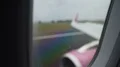 Plane wing and engine seen through rainy window during shaky landing on runway 4k or 4k+ Resolution
