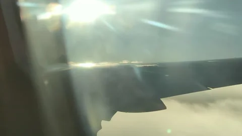 Plane wing clouds in the air sun flare Stock Footage 221593372
