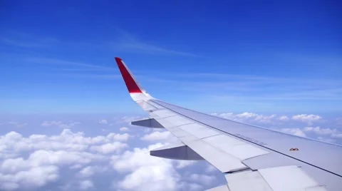 Plane Wing Flying Above the Clouds in the Sky Видео 49695359