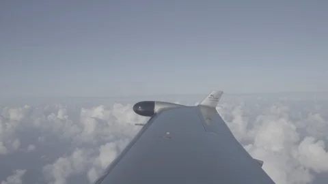 Plane wing flying above clouds Stock Footage 105733769