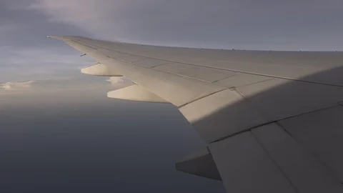 Plane wing flying in the sky, view of shadow outside plane window Stock Footage 107093398