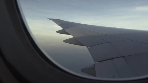 Plane wing flying in the sky, view of shadow outside plane window Stock Footage 107093428