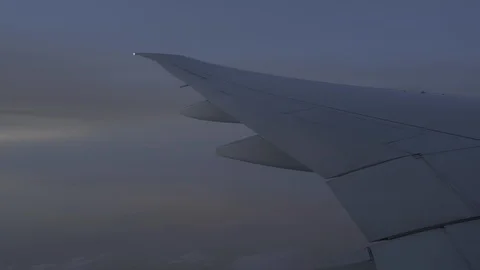 Plane wing flying in the sky, view of evening sky outside window plane Stock Footage 107093573