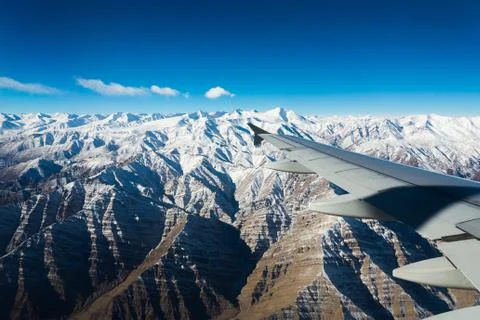 Plane wing snow mountain view Stock Photos