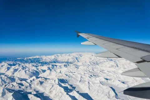 Plane wing snow mountain view Stock Photos