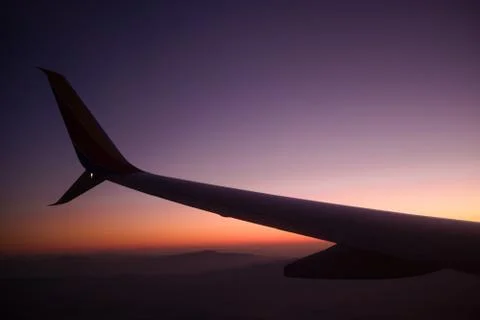 Plane Wing at Sunset Stock Photos