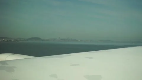 Plane wing view of San Francisco downtown skyscapers in distance Stock Footage 236351812